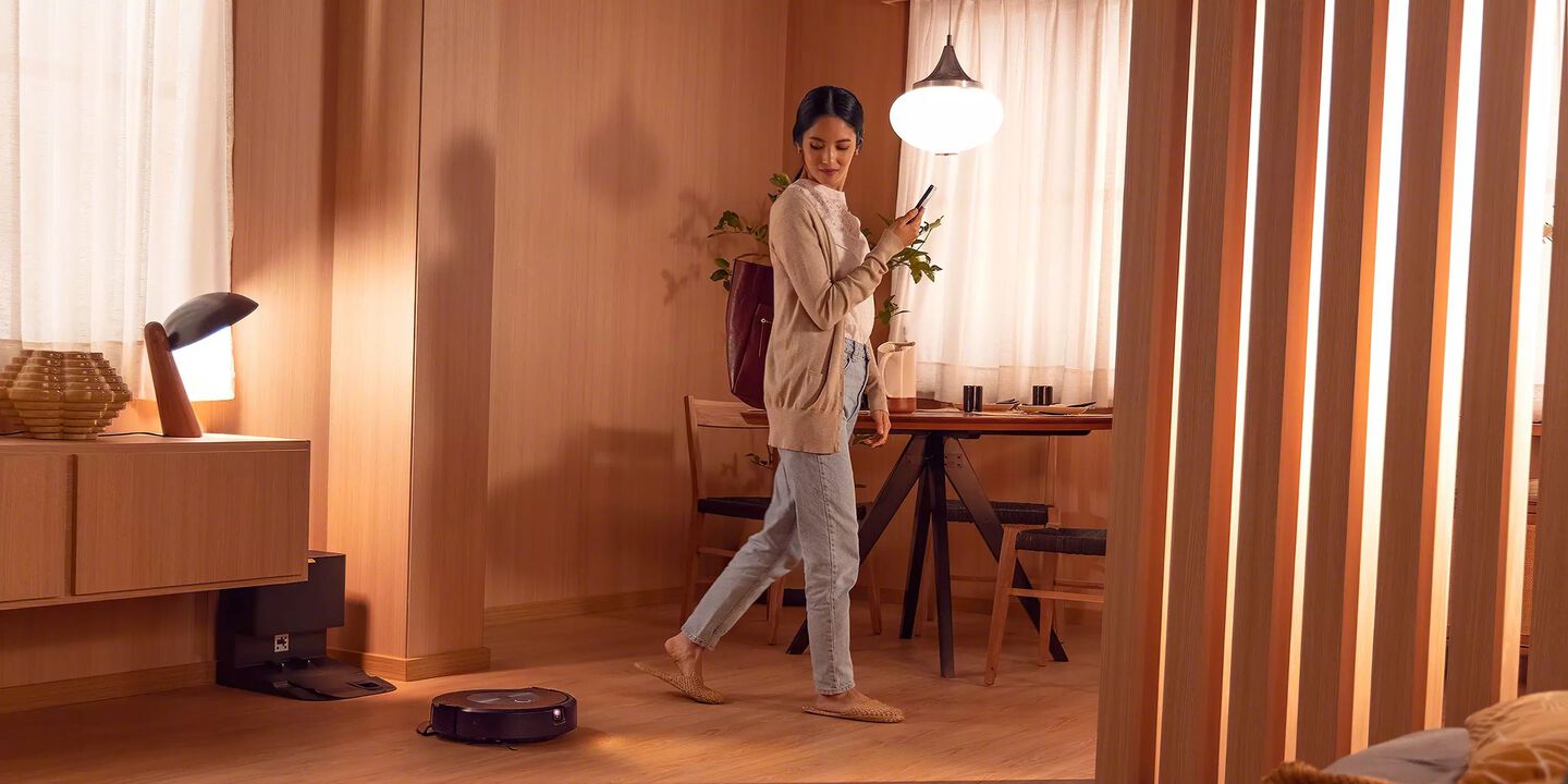 Woman walking by Roomba Combo